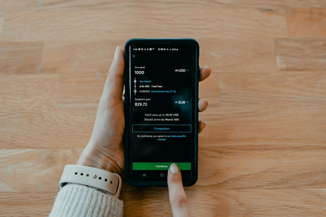 woman checking smartphone budget app