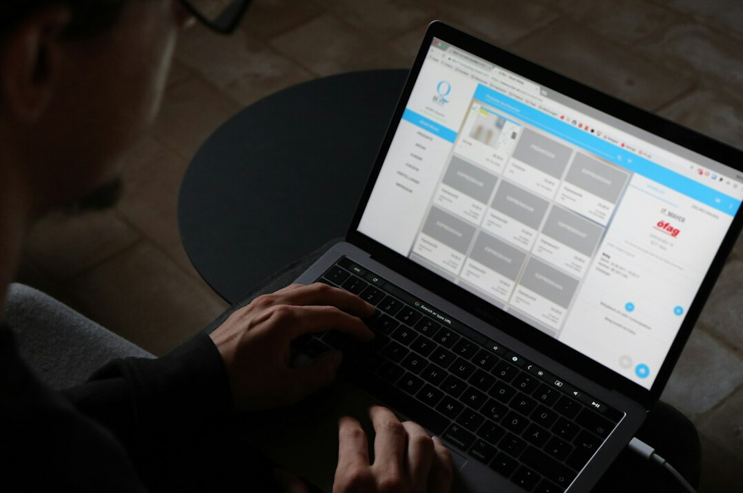 man using finance app on laptop