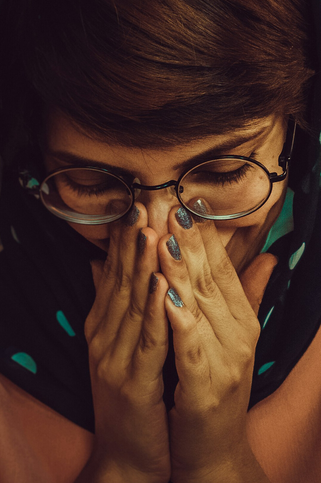 Studio photo of a Polish woman in her 50s with short dark hair and glasses